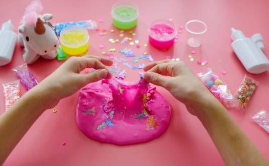 Girl making pink slim at home