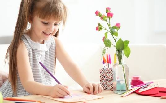 Kid designing greeting cards to sell